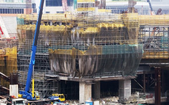 Workers toil on the terminus